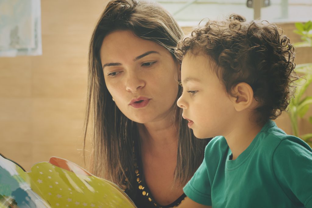 A mom reads a book with her young son