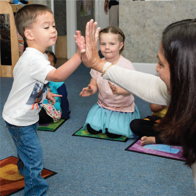 A child high-fives Benu