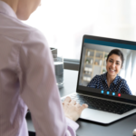 Looking over the shoulder of a person on a video call with a woman