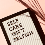 A tablet showing the words, "self care isn't selfish"