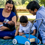 A family sits together at the park
