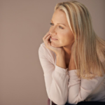 A woman sits lost in thought